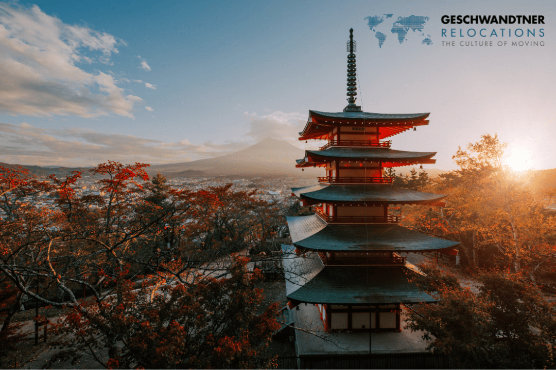 a pagoda with trees and mountains in the background